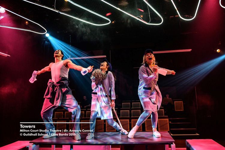 Actors dance and sing on tables